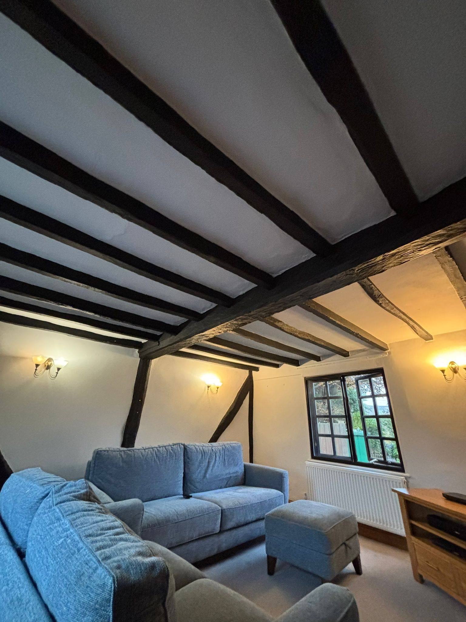 Black-stained ceiling beams — before