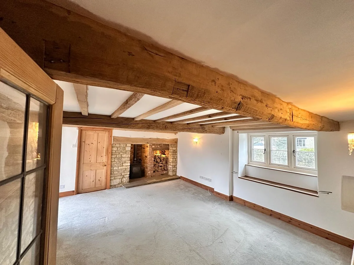 Restored oak beams and stone fireplace